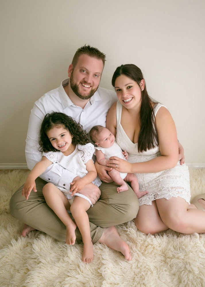 Newborn family in white neutrals