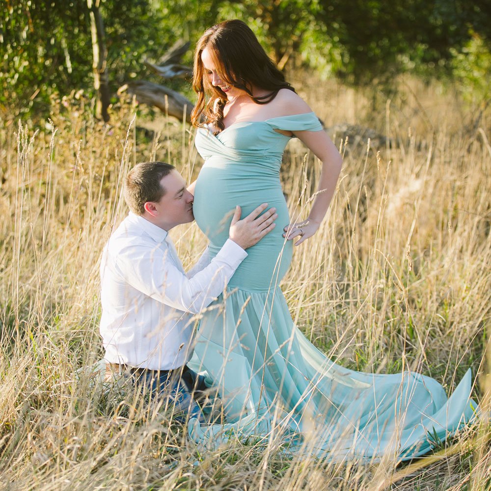 Maternity wardrobe — sage green gown outdoors